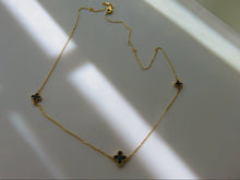 Load image into Gallery viewer, Gold necklace with green gemstones on a white surface
